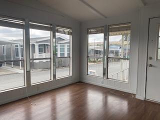 144 Holm Road, Unit 119 Watsonville, CA 95076 - Photo 7 of 29 a view of room with wooden floor and windows