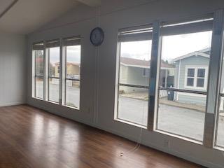 144 Holm Road, Unit 119 Watsonville, CA 95076 - Photo 8 of 29 a view of an empty room with wooden floor and a window