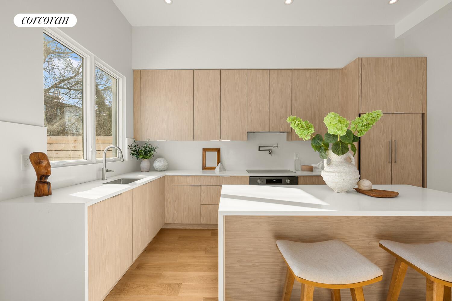 1148 Decatur Street Brooklyn, NY 11207 - Photo 4 of 14 a kitchen with a sink cabinets and a table