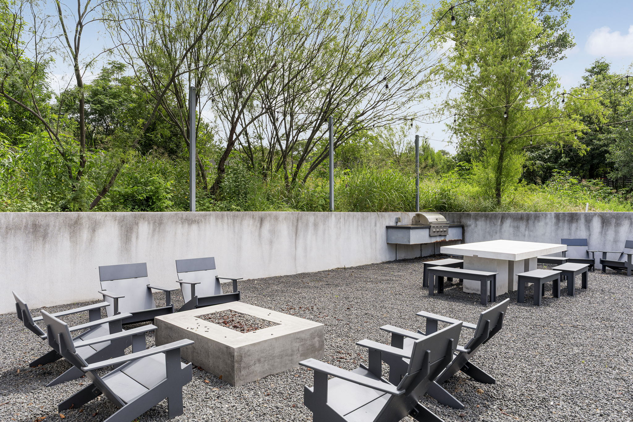 2520 Sutherland Street Austin, TX 78746 - Photo 26 of 26 The Community Outdoor Lounge is a inviting outdoor space featuring a built-in barbecue and a cozy fire pit.