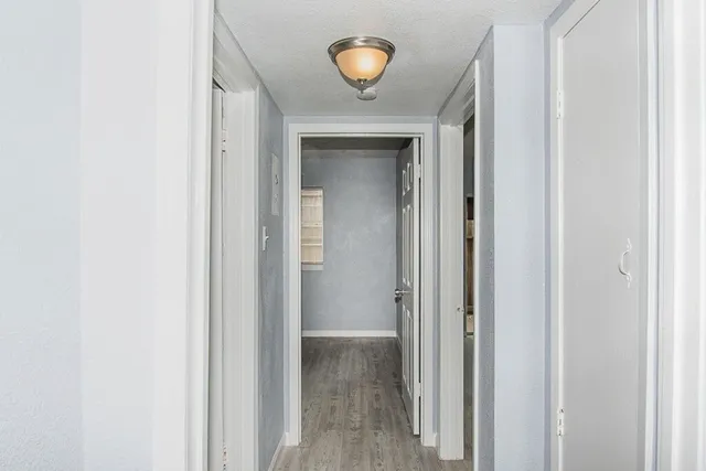 a kitchen with granite countertop white cabinets and stainless steel appliances