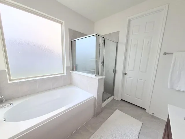 a bathroom with a bathtub and a shower