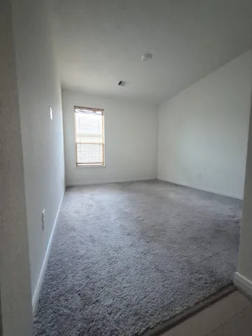 an empty room with a empty space and windows