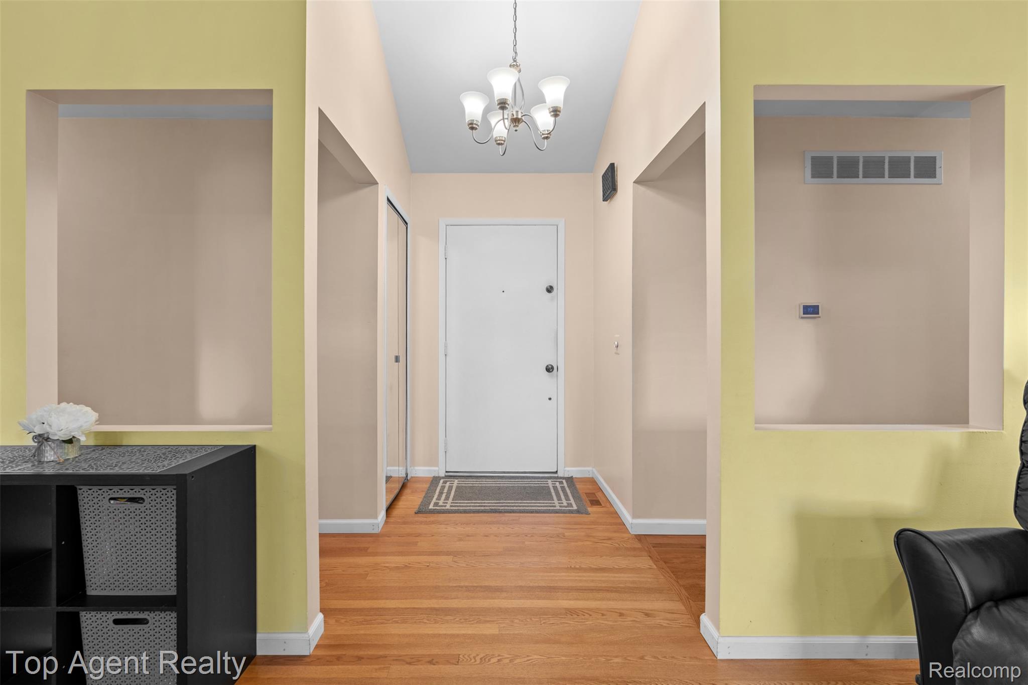 1351 Milverton Road Troy, MI 48083 - Photo 6 of 42 Foyer featuring wood finished floors and a chandelier