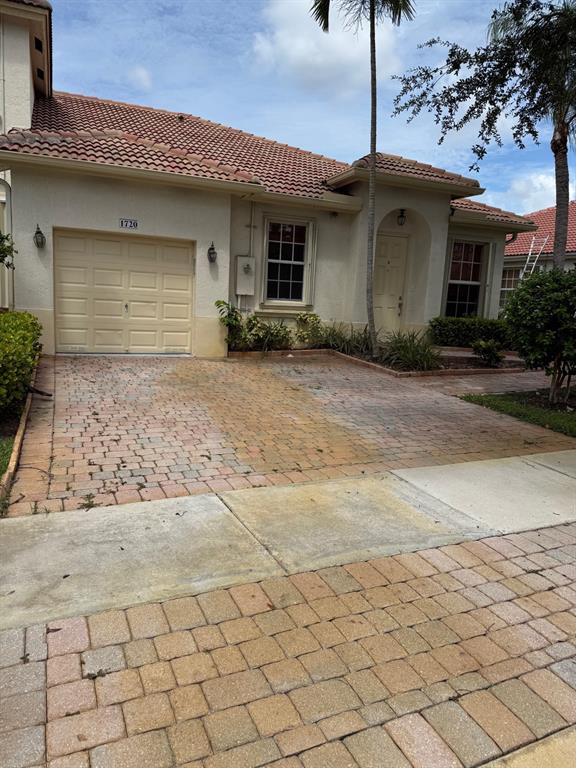 1720 Northwest 78th Way, Unit 1720 Pembroke Pines, FL 33024 - Photo 2 of 9 a front view of a house with a yard