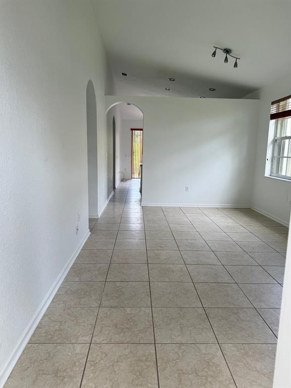 1720 Northwest 78th Way, Unit 1720 Pembroke Pines, FL 33024 - Photo 8 of 9 a view of a livingroom with an empty space and a window