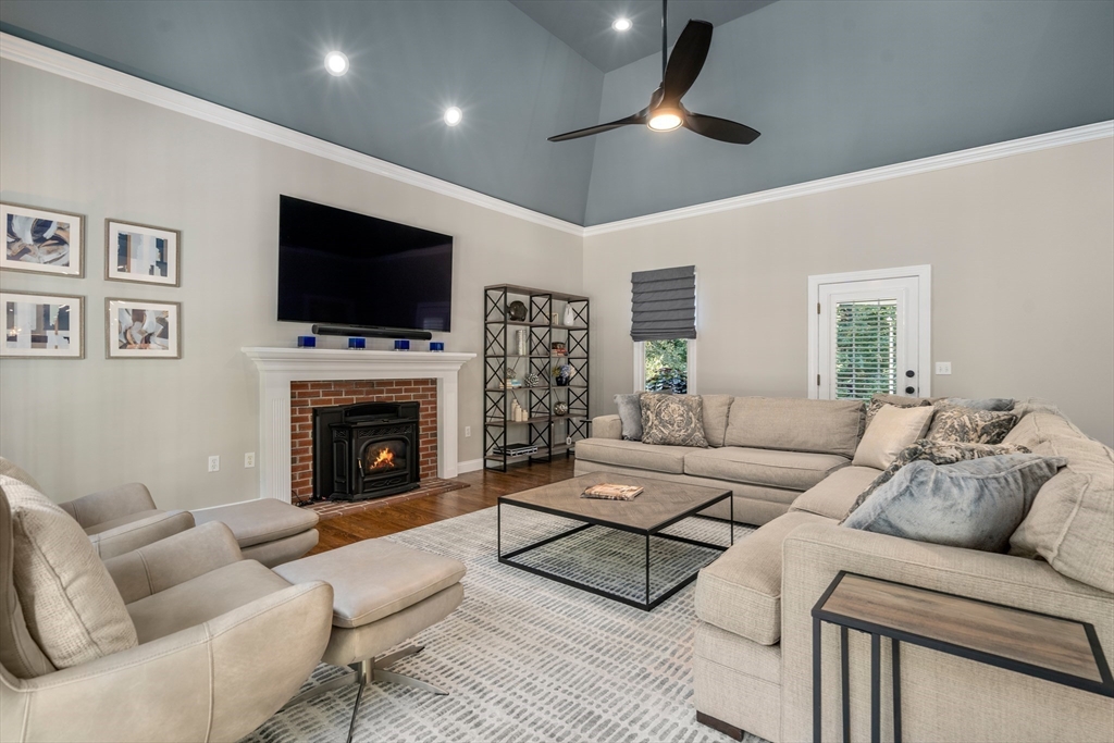 9 MacIntyre Drive North Reading, MA 01864 - Photo 12 of 41 a living room with furniture a fireplace and a flat screen tv