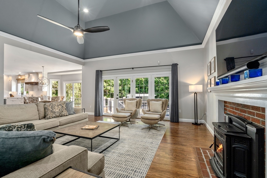 9 MacIntyre Drive North Reading, MA 01864 - Photo 13 of 41 a living room with furniture a large window and a fireplace