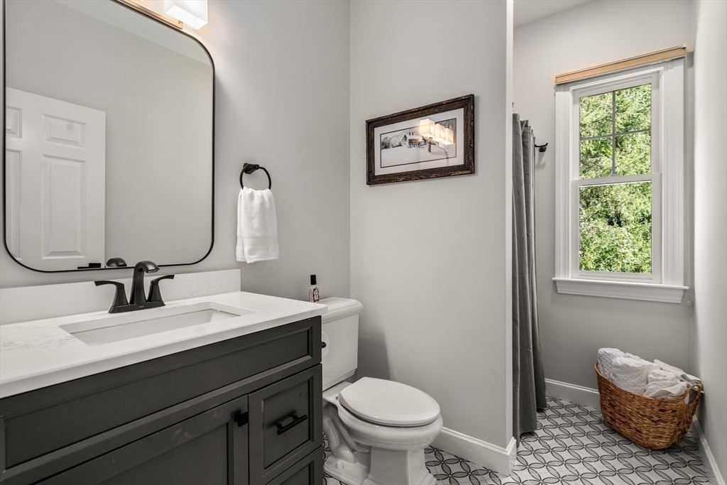 9 MacIntyre Drive North Reading, MA 01864 - Photo 16 of 41 a bathroom with a granite countertop toilet sink and mirror