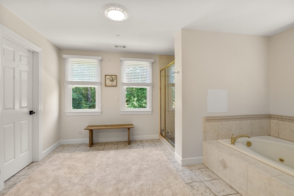 9 MacIntyre Drive North Reading, MA 01864 - Photo 20 of 41 a spacious bathroom with a bathtub and a shower