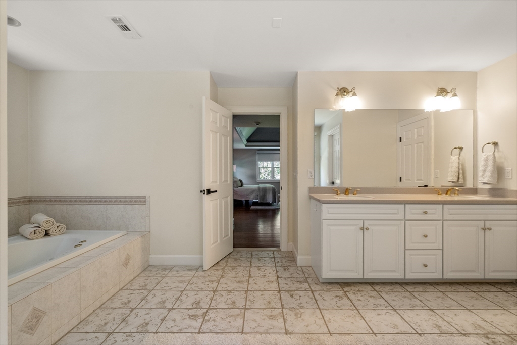 9 MacIntyre Drive North Reading, MA 01864 - Photo 21 of 41 a spacious bathroom with a granite countertop sink mirror and bathtub