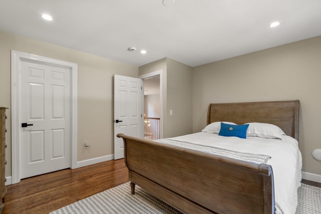 9 MacIntyre Drive North Reading, MA 01864 - Photo 24 of 41 a bedroom with a bed and wooden floor