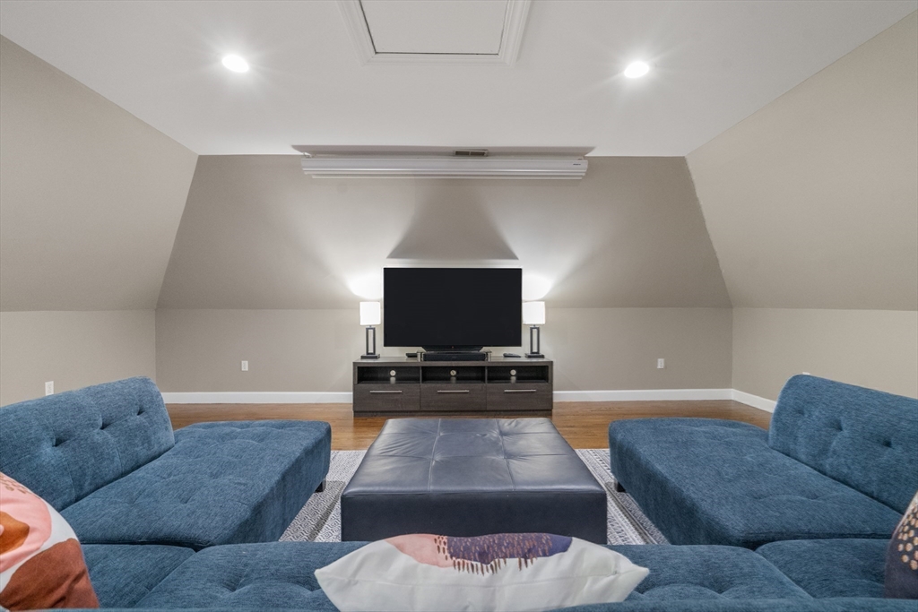 9 MacIntyre Drive North Reading, MA 01864 - Photo 27 of 41 a living room with furniture and a flat screen tv