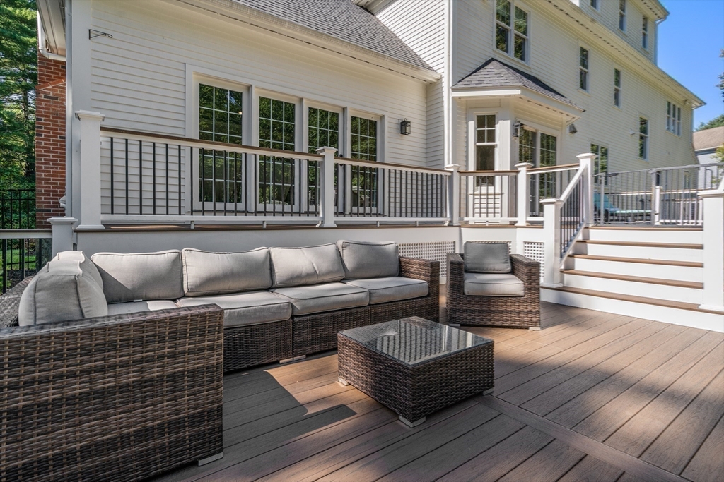 9 MacIntyre Drive North Reading, MA 01864 - Photo 28 of 41 a view of a patio with couches and a dining table with wooden floor