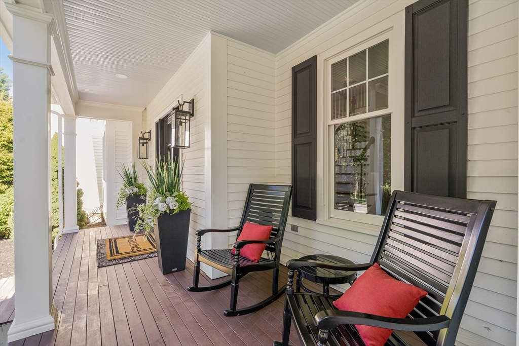 9 MacIntyre Drive North Reading, MA 01864 - Photo 3 of 41 a balcony with furniture and wooden floor