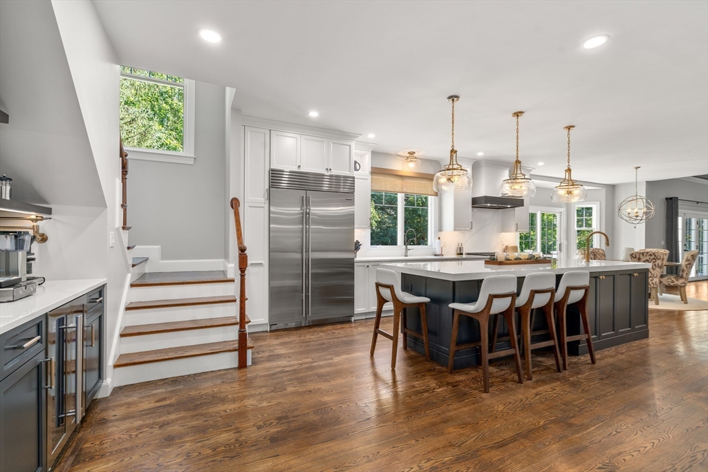 9 MacIntyre Drive North Reading, MA 01864 - Photo 8 of 41 a kitchen with stainless steel appliances kitchen island granite countertop a table chairs sink and cabinets