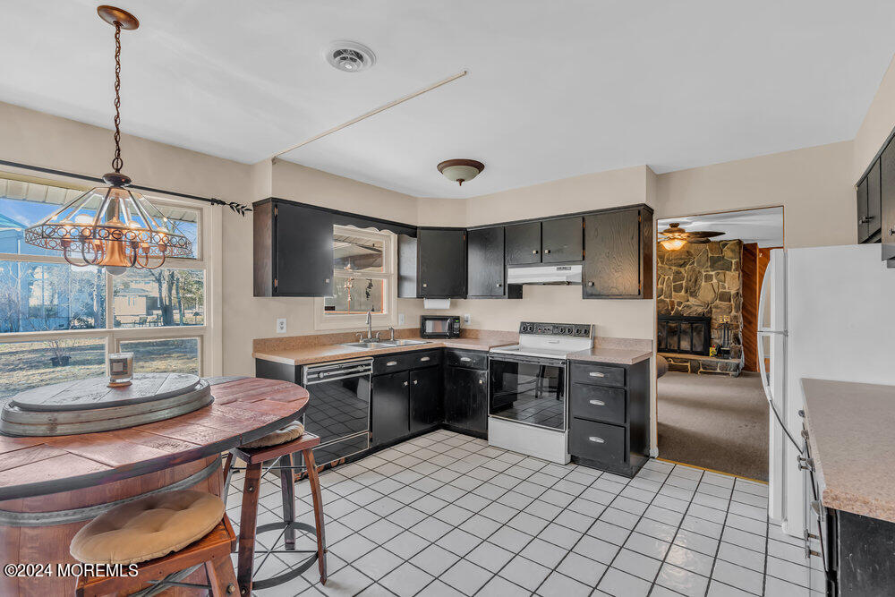 1400 Lanes Mill Road Lakewood, NJ 08701 - Photo 16 of 40 a kitchen with sink cabinets and stainless steel appliances