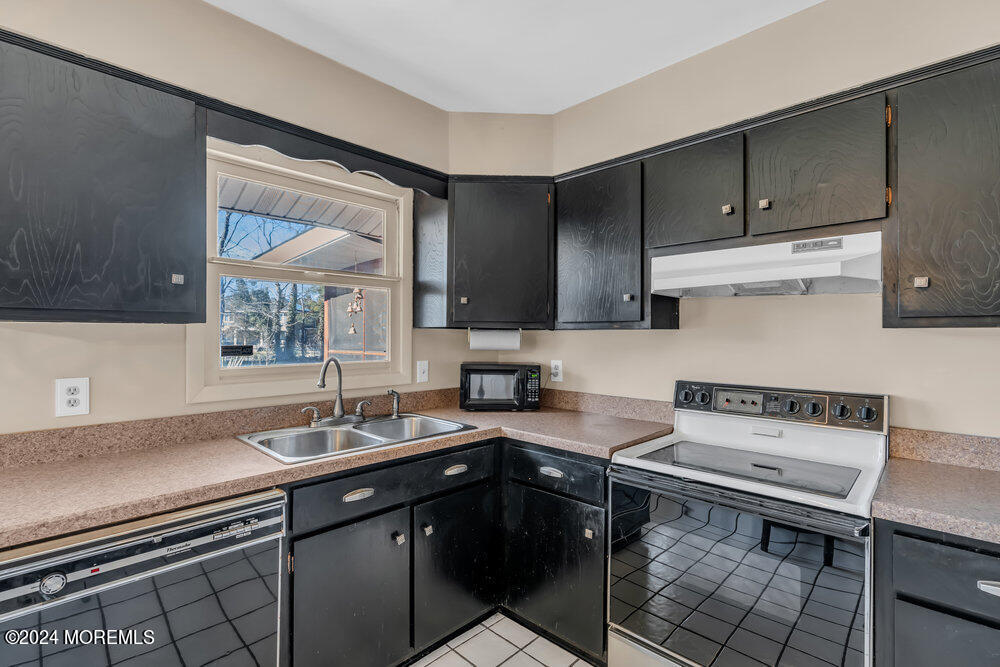 1400 Lanes Mill Road Lakewood, NJ 08701 - Photo 18 of 40 a kitchen with a sink cabinets and stainless steel appliances
