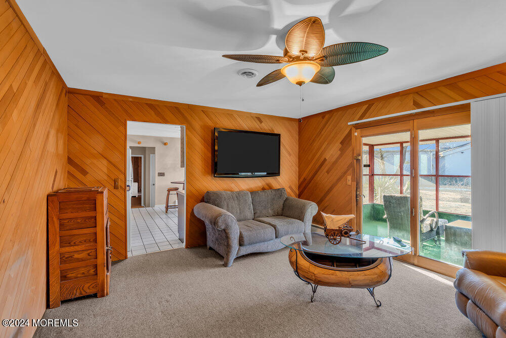 1400 Lanes Mill Road Lakewood, NJ 08701 - Photo 22 of 40 a living room with furniture a flat screen tv and a large window