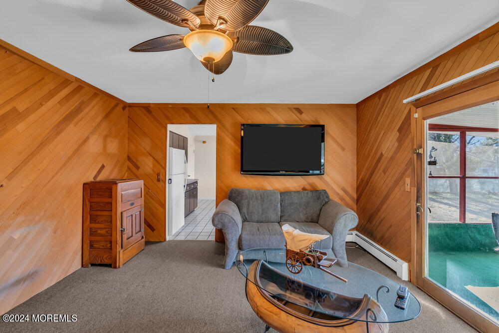 1400 Lanes Mill Road Lakewood, NJ 08701 - Photo 23 of 40 a living room with furniture and a floor to ceiling window