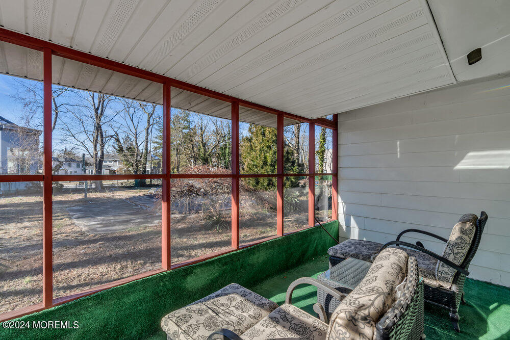 1400 Lanes Mill Road Lakewood, NJ 08701 - Photo 25 of 40 a porch with a bench next to a yard