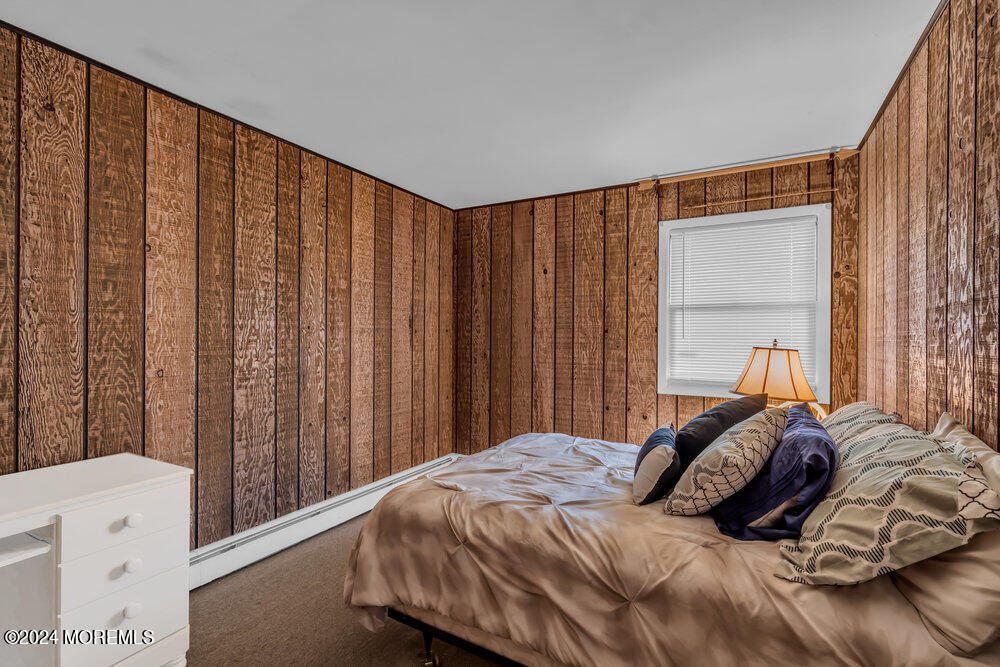 1400 Lanes Mill Road Lakewood, NJ 08701 - Photo 35 of 40 a bed sitting in a bedroom next to a window