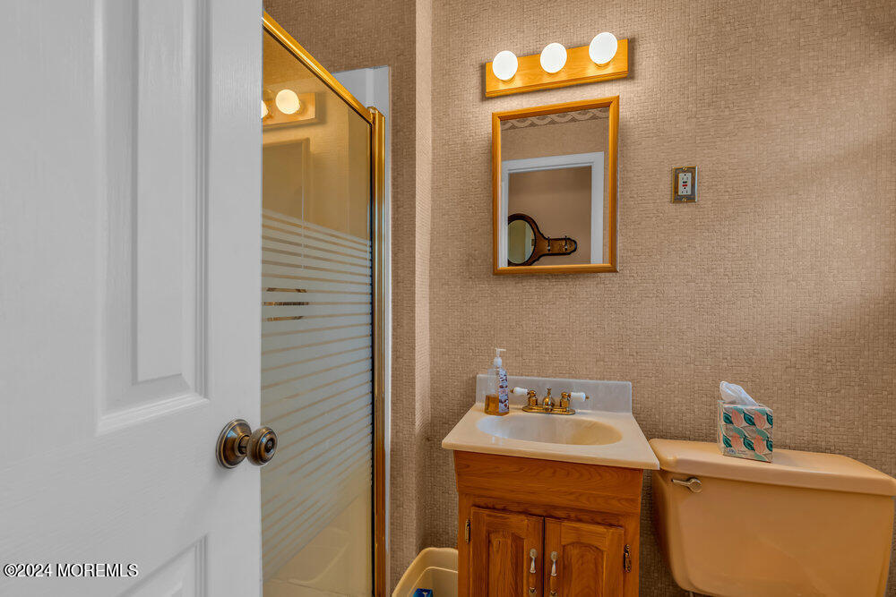 1400 Lanes Mill Road Lakewood, NJ 08701 - Photo 36 of 40 a bathroom with a sink a toilet and mirror