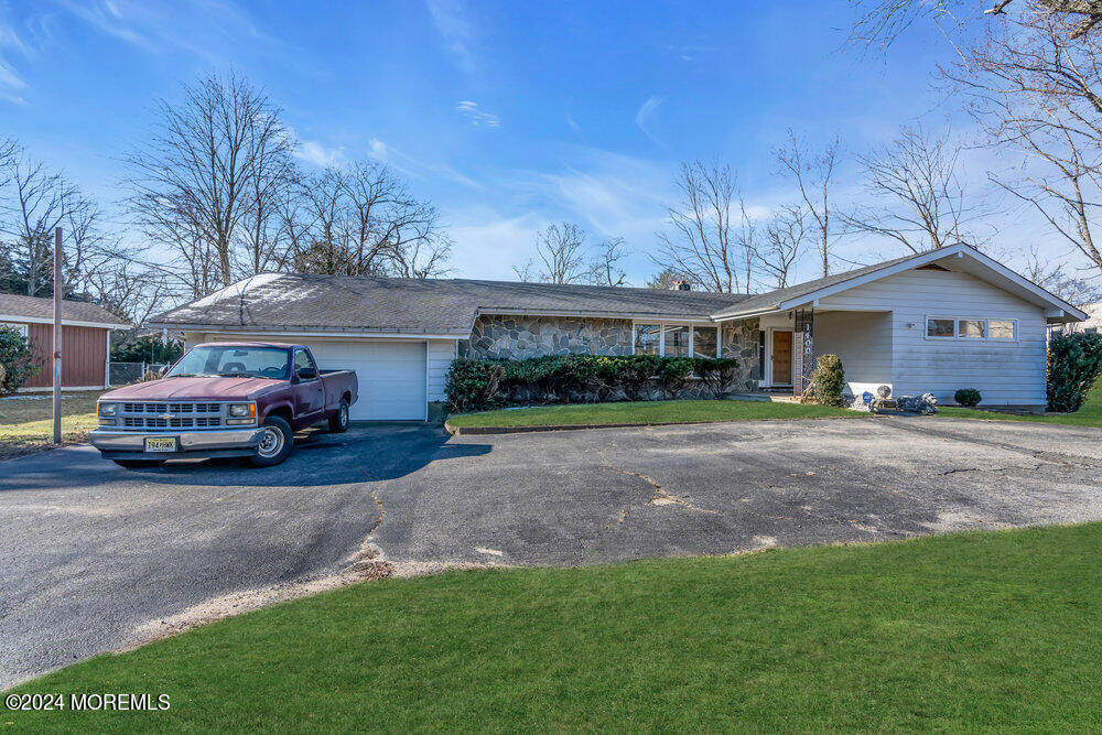 1400 Lanes Mill Road Lakewood, NJ 08701 - Photo 9 of 40 a view of a house with a garden and parking space