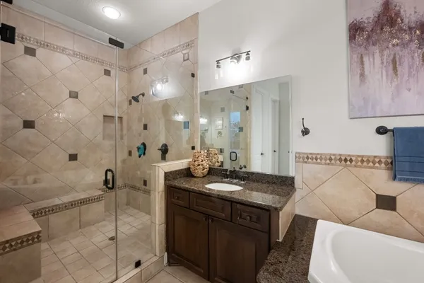 a large bathroom with a large tub and sink
