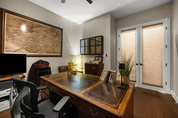 a room with furniture a bookshelf and a flat screen tv