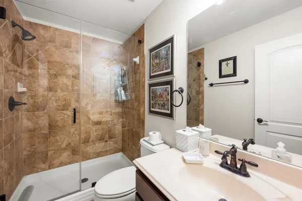 a bathroom with a sink toilet and shower