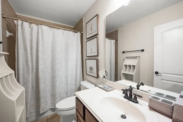 a bathroom with a sink a toilet and a mirror