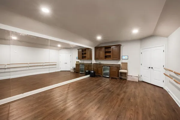 an empty room with wooden floor and furniture