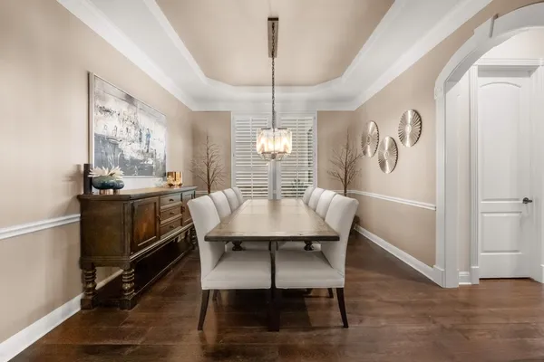 a view of a a dining room with furniture window and wooden floor