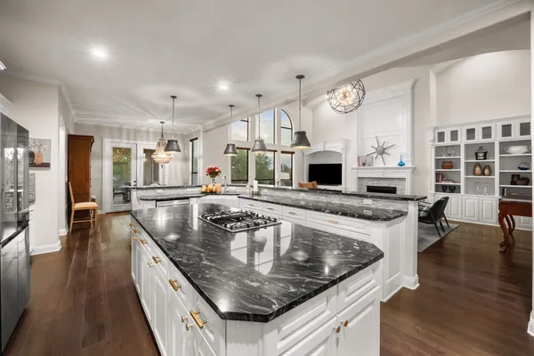 a kitchen with stainless steel appliances granite countertop a lot of counter space