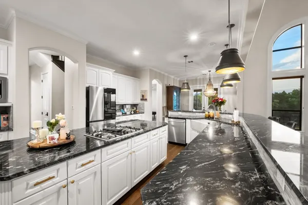 a kitchen with sink refrigerator and stove