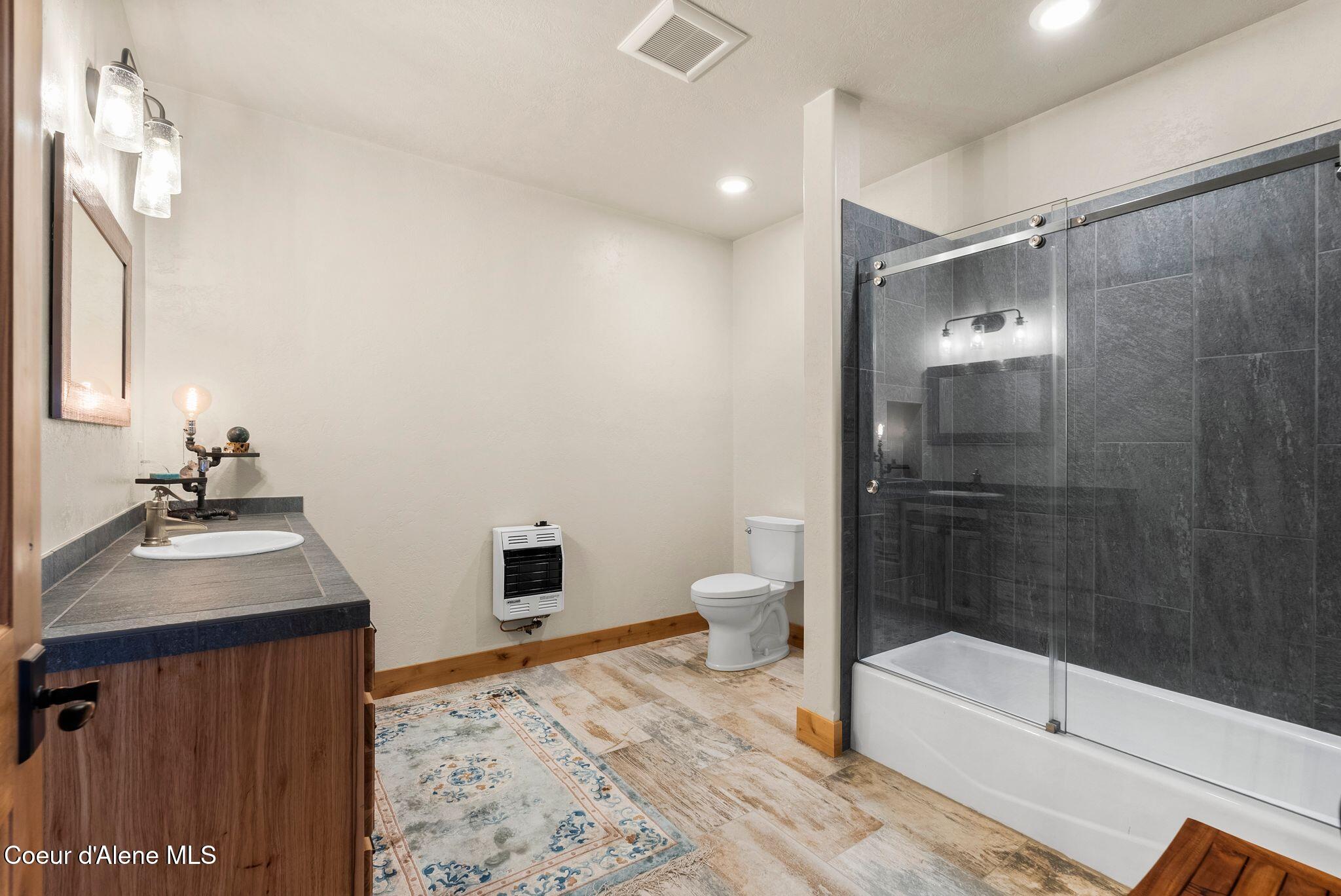 422 Lightning Peak Road Sandpoint, ID 83864 - Photo 48 of 92 Guest bathroom with tile accents