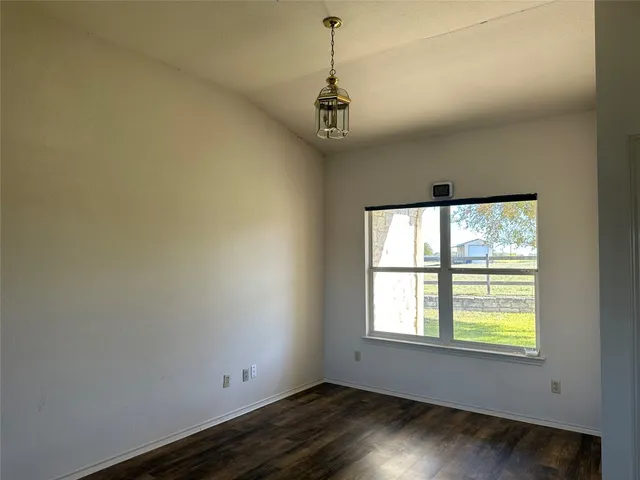 a view of wooden floor and windows in a room