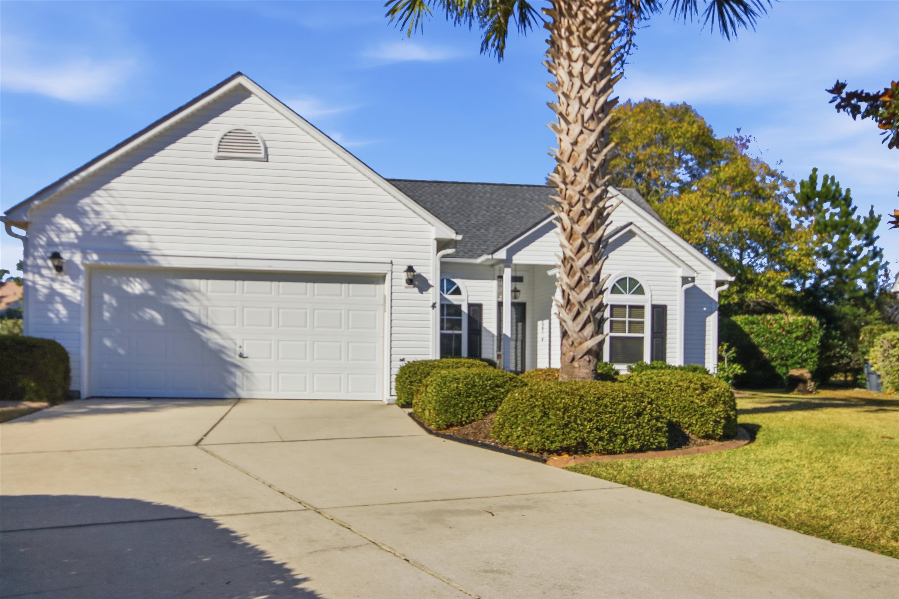 4 Guillemont Court Murrells Inlet, SC 29576 - Photo 2 of 40 View of front of home with concrete driveway, a front lawn, and an attached garage