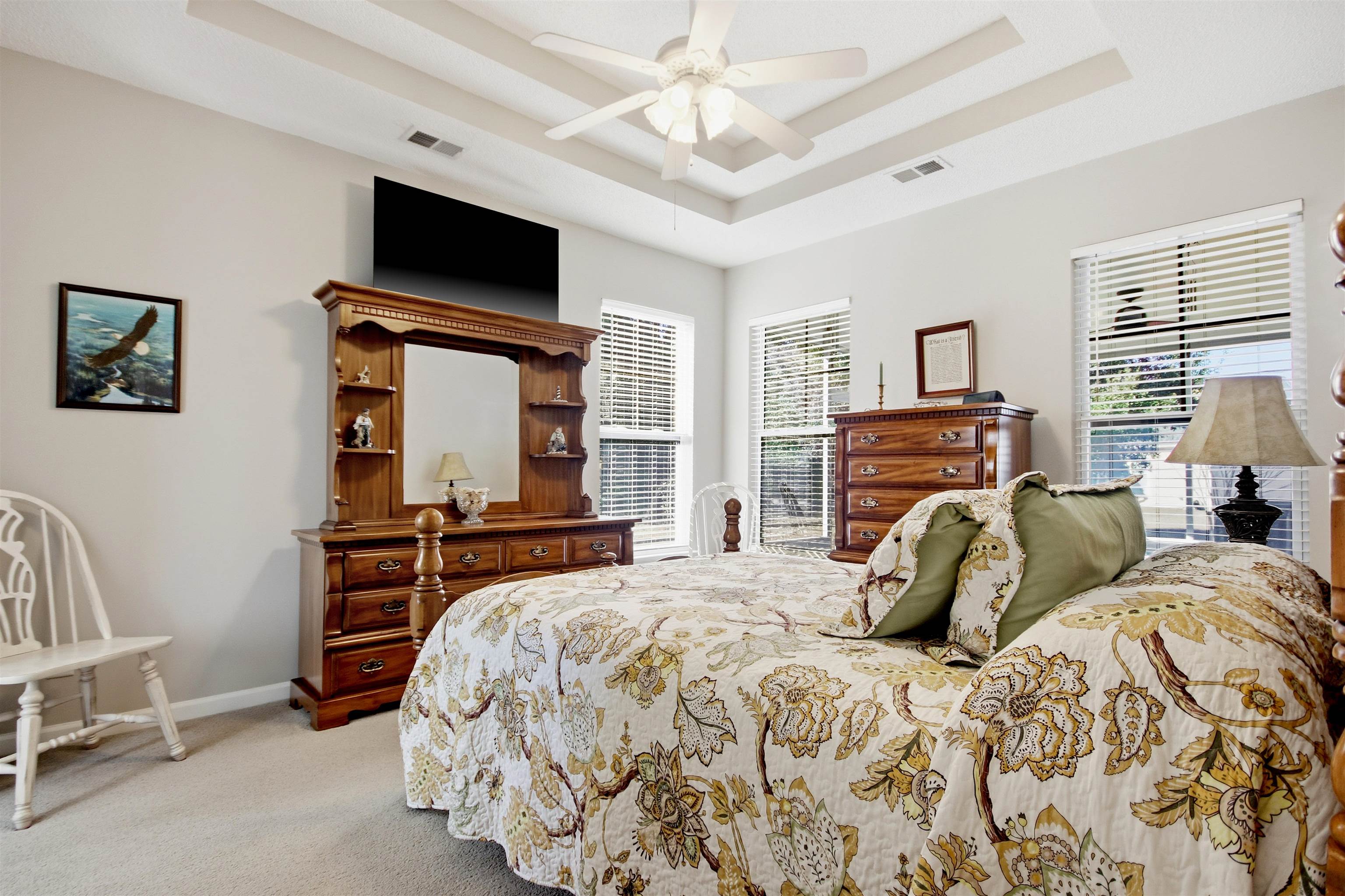 4 Guillemont Court Murrells Inlet, SC 29576 - Photo 23 of 40 Bedroom with a raised ceiling, light colored carpet, and a ceiling fan