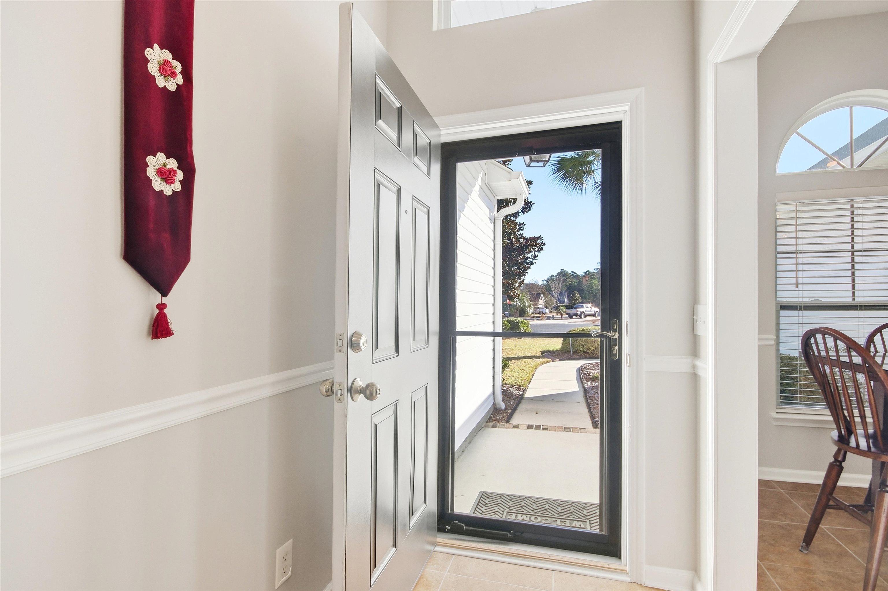 4 Guillemont Court Murrells Inlet, SC 29576 - Photo 4 of 40 Entryway with light tile patterned floors and healthy amount of natural light