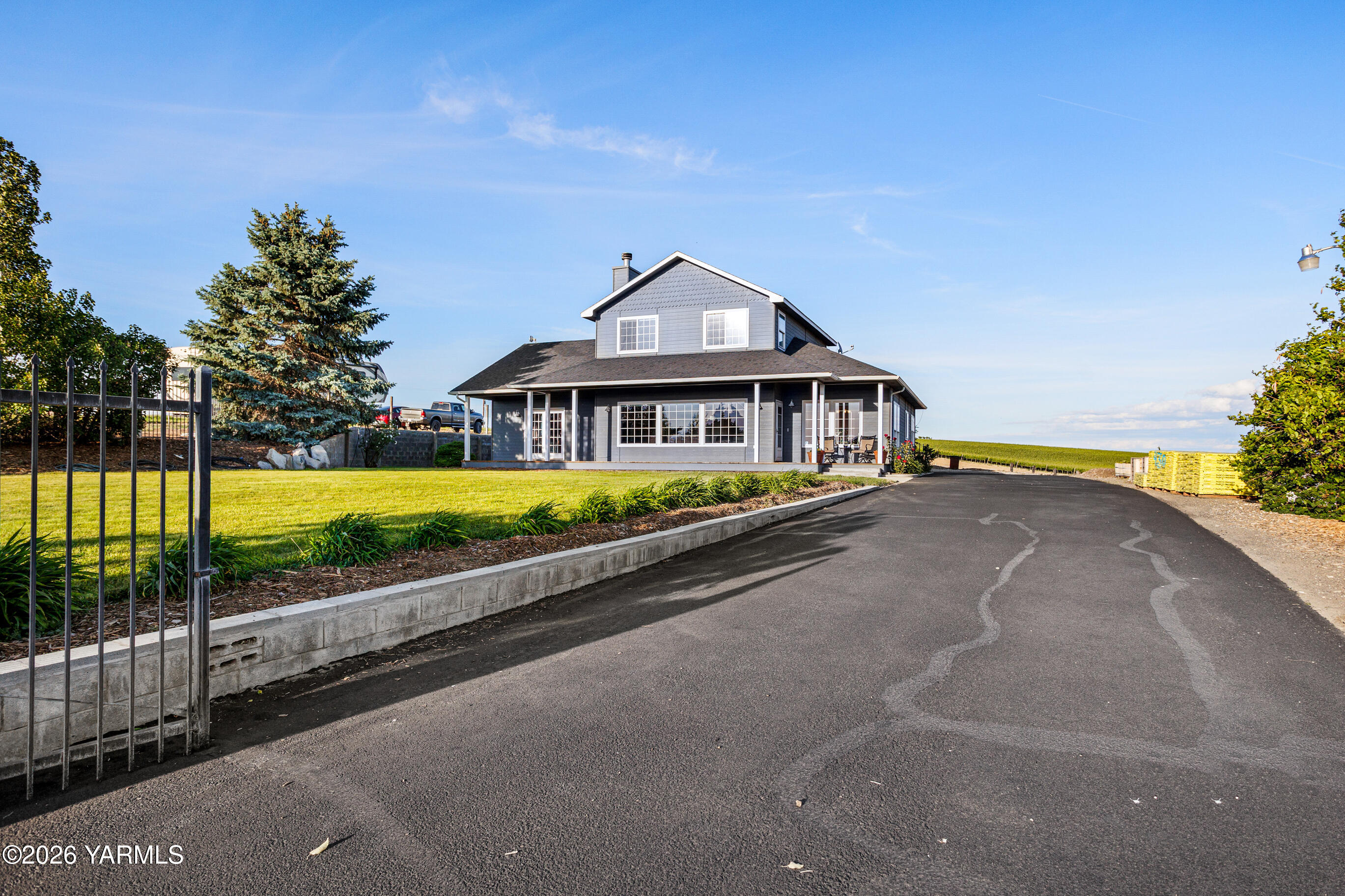 5060 Lombard Loop Road Zillah, WA 98953 - Photo 3 of 65 a view of a house with swimming pool and a yard