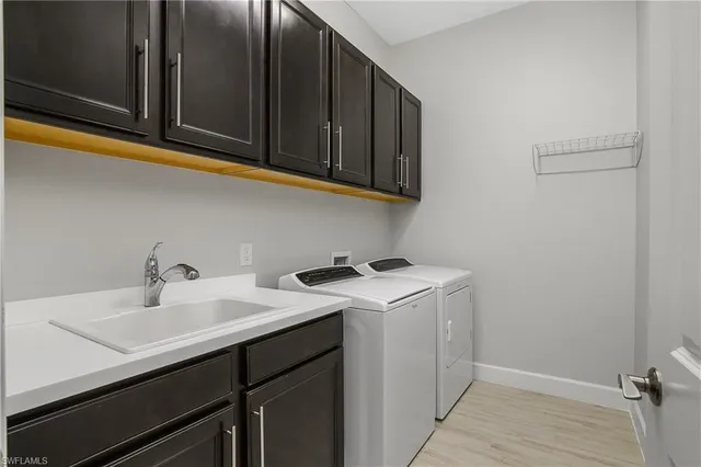 a utility room with sink dryer and washer