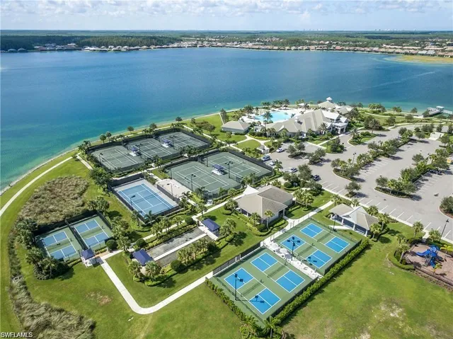 an aerial view of a residential houses with outdoor space and ocean view