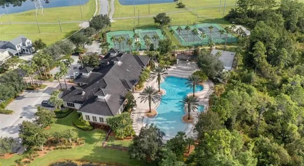 an aerial view of residential house with outdoor space and trees all around