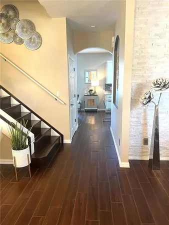 a view of a bedroom with wooden floor and furniture