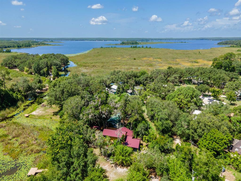 23610 Northeast 154th Place Road Fort McCoy, FL 32134 - Photo 1 of 44 a view of a city with lush green forest
