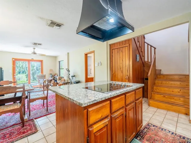 a kitchen with granite countertop stainless steel appliances a stove sink and microwave