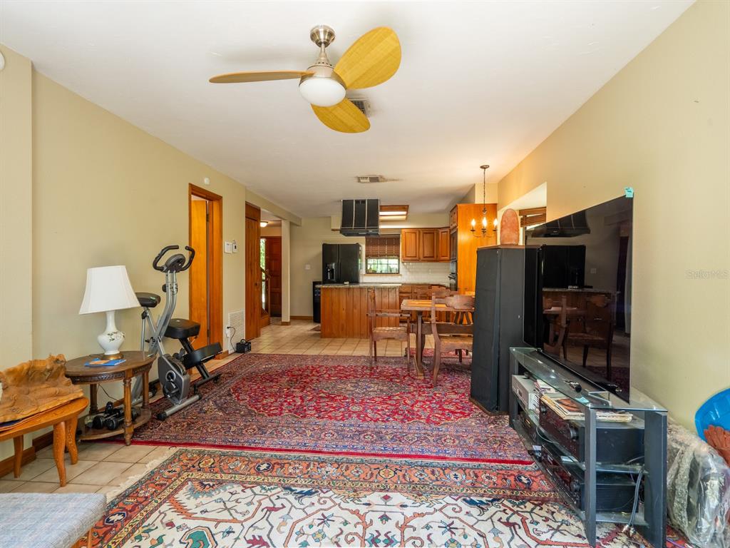 23610 Northeast 154th Place Road Fort McCoy, FL 32134 - Photo 15 of 44 a living room with furniture and a flat screen tv