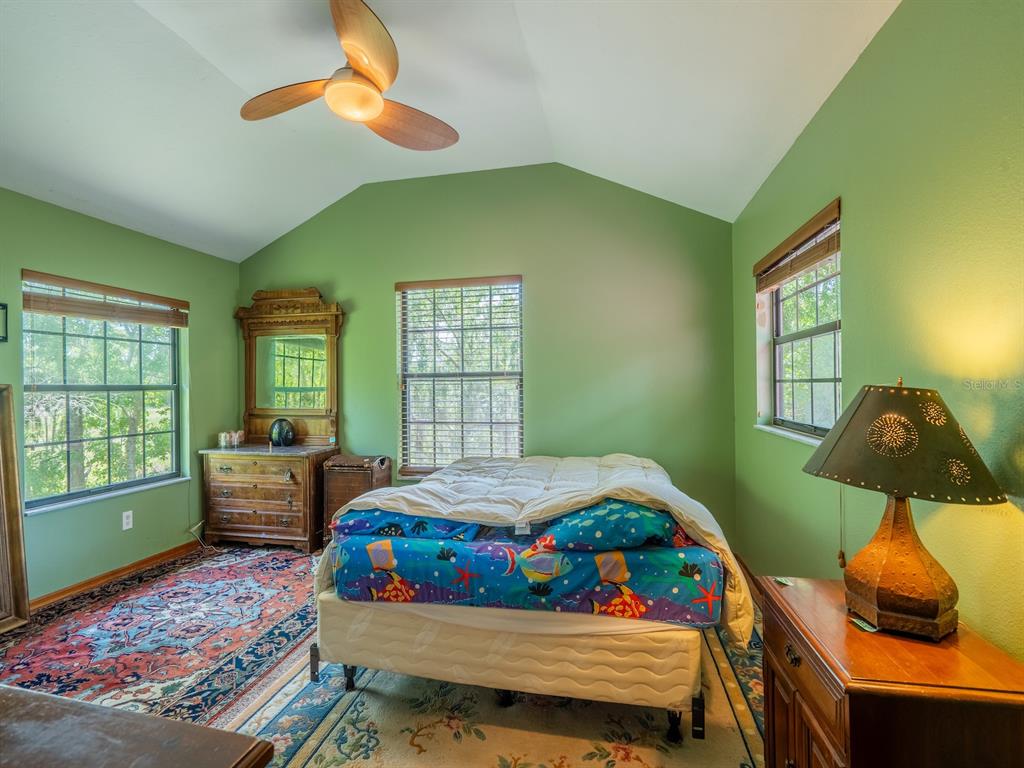 23610 Northeast 154th Place Road Fort McCoy, FL 32134 - Photo 26 of 44 a bedroom with two beds and a window